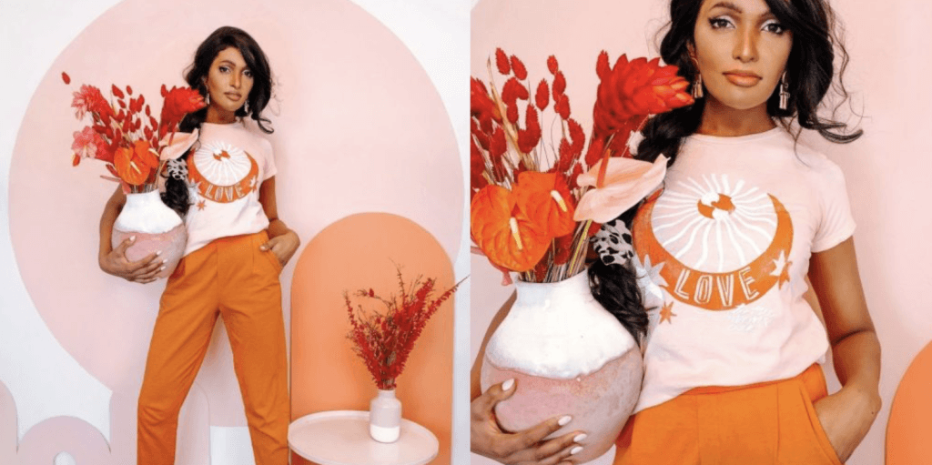 Two people in orange outfits holding flowers